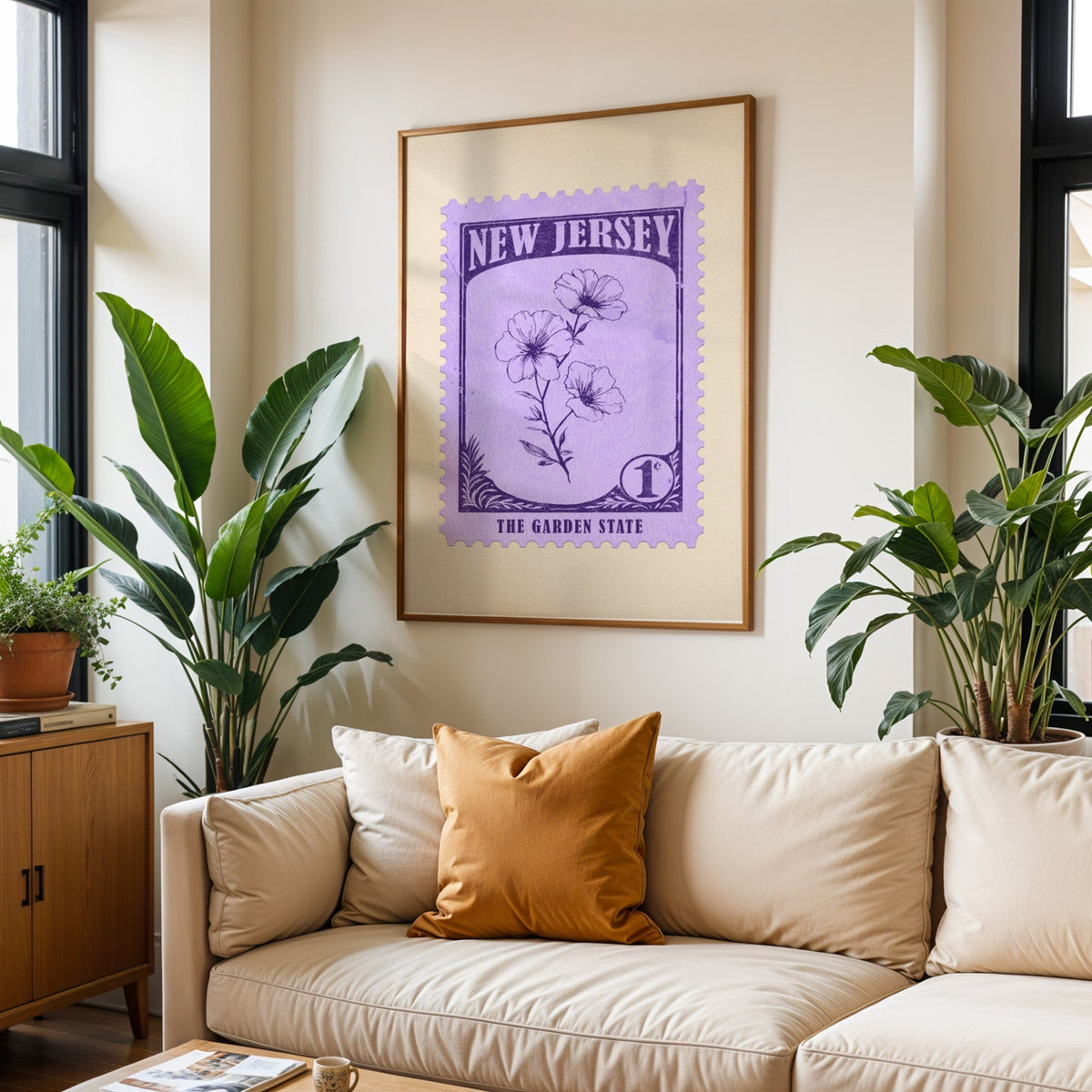 New Jersey state flower print framed above a cream sofa with an ochre cushion and large plants either side