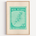 New Mexico state flower stamp print in emerald on mint, light oak frame on a plain white wall