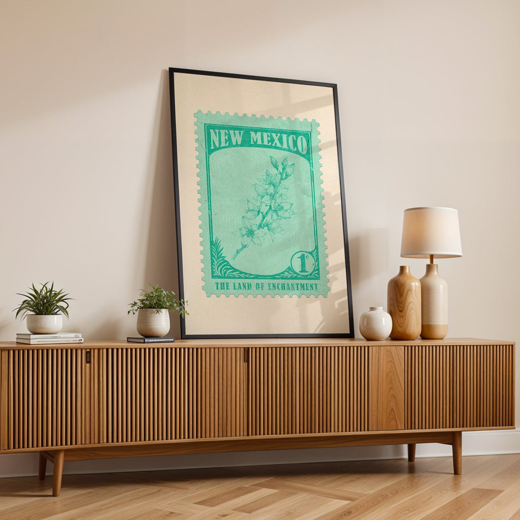 New Mexico state flower print in a black frame leaning on a fluted wood credenza with vases and a lamp