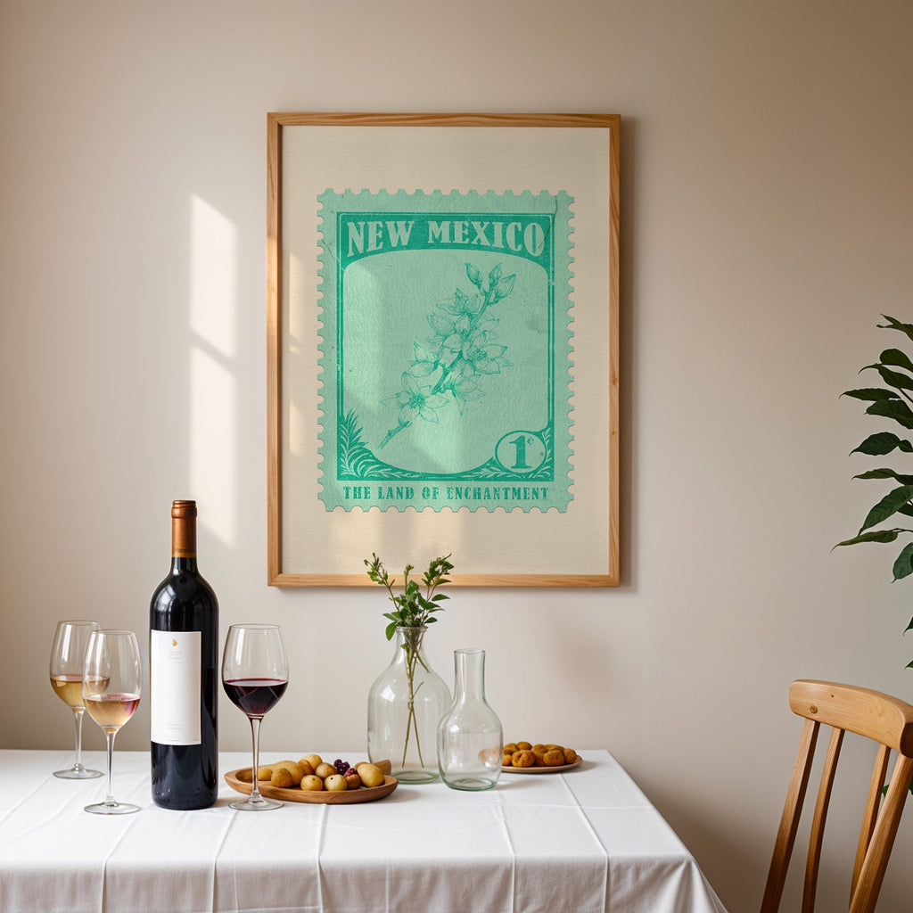 New Mexico stamp print framed on the wall above a dining table set with wine, glasses and olives