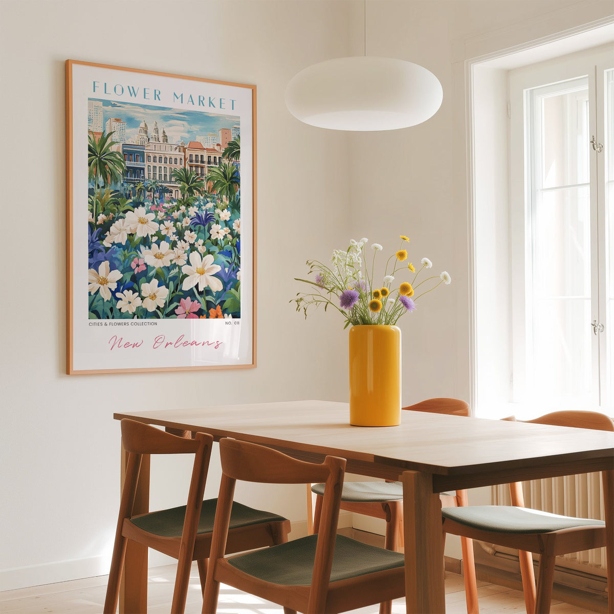 New Orleans flower market print in an oak frame above a dining table with a yellow vase and white pendant light