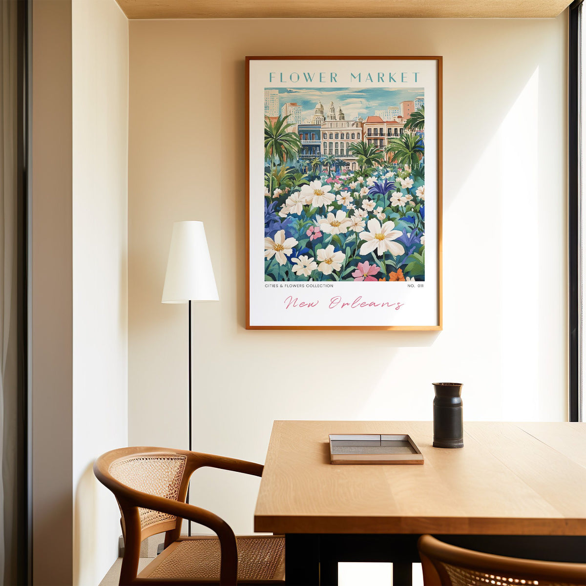New Orleans flower market print in an oak frame above a dining table and cane chair
