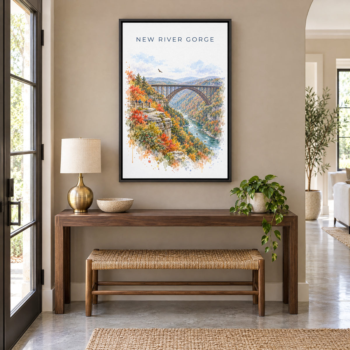 New River Gorge National Park watercolor as a black floater canvas above a walnut console and woven bench in an entryway