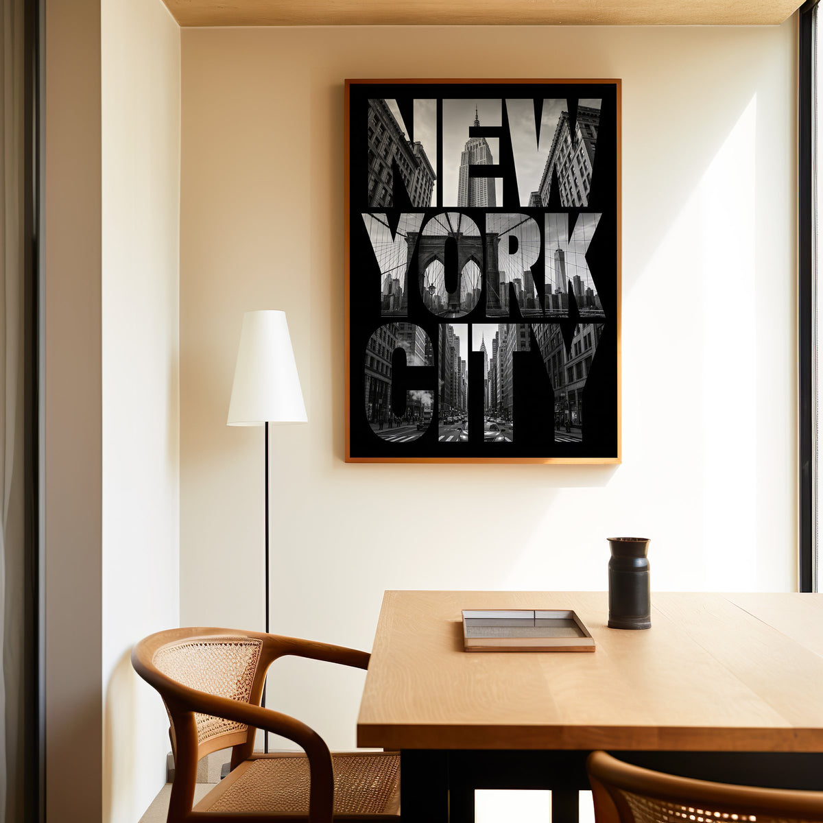 New York City letters filled with skyline photo print in an oak frame above a dining table and cane chair