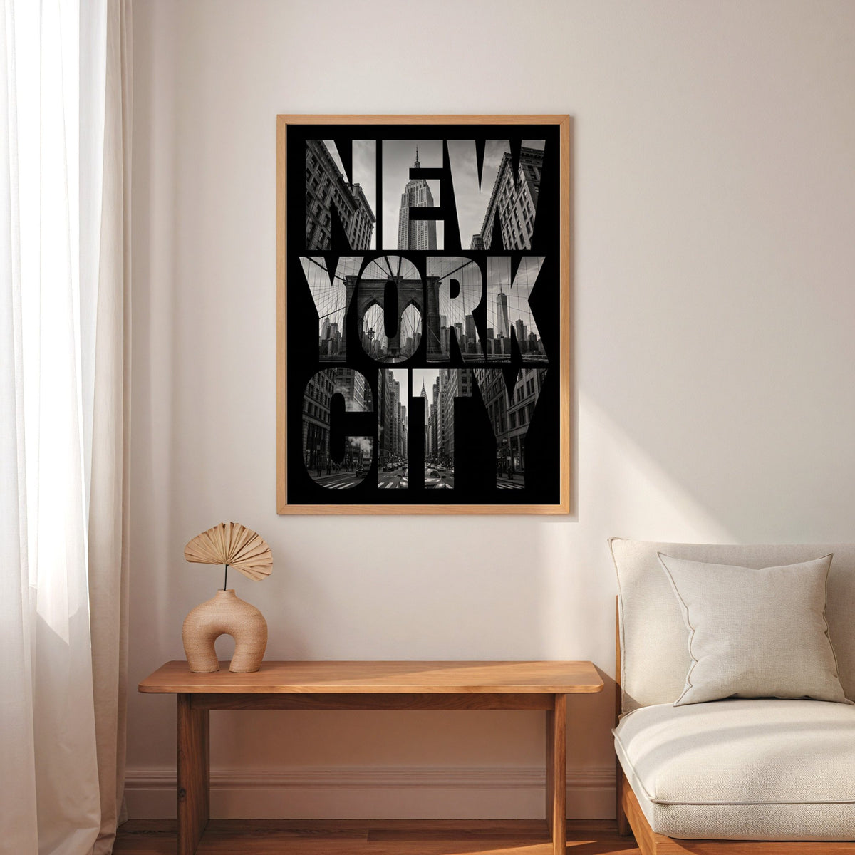 New York City letters filled with skyline photo print in an oak frame above a narrow console with an arched vase