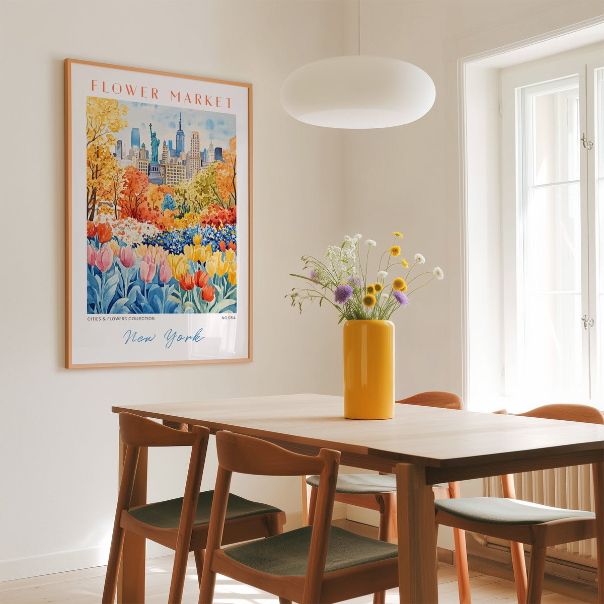 New York flower market print in an oak frame above a dining table with a yellow vase and white pendant light
