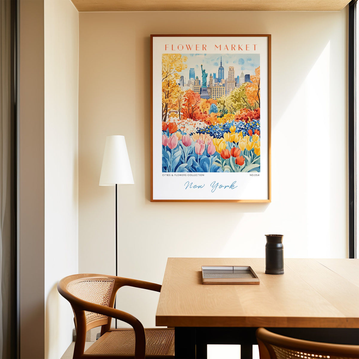 New York flower market print in an oak frame above a dining table and cane chair