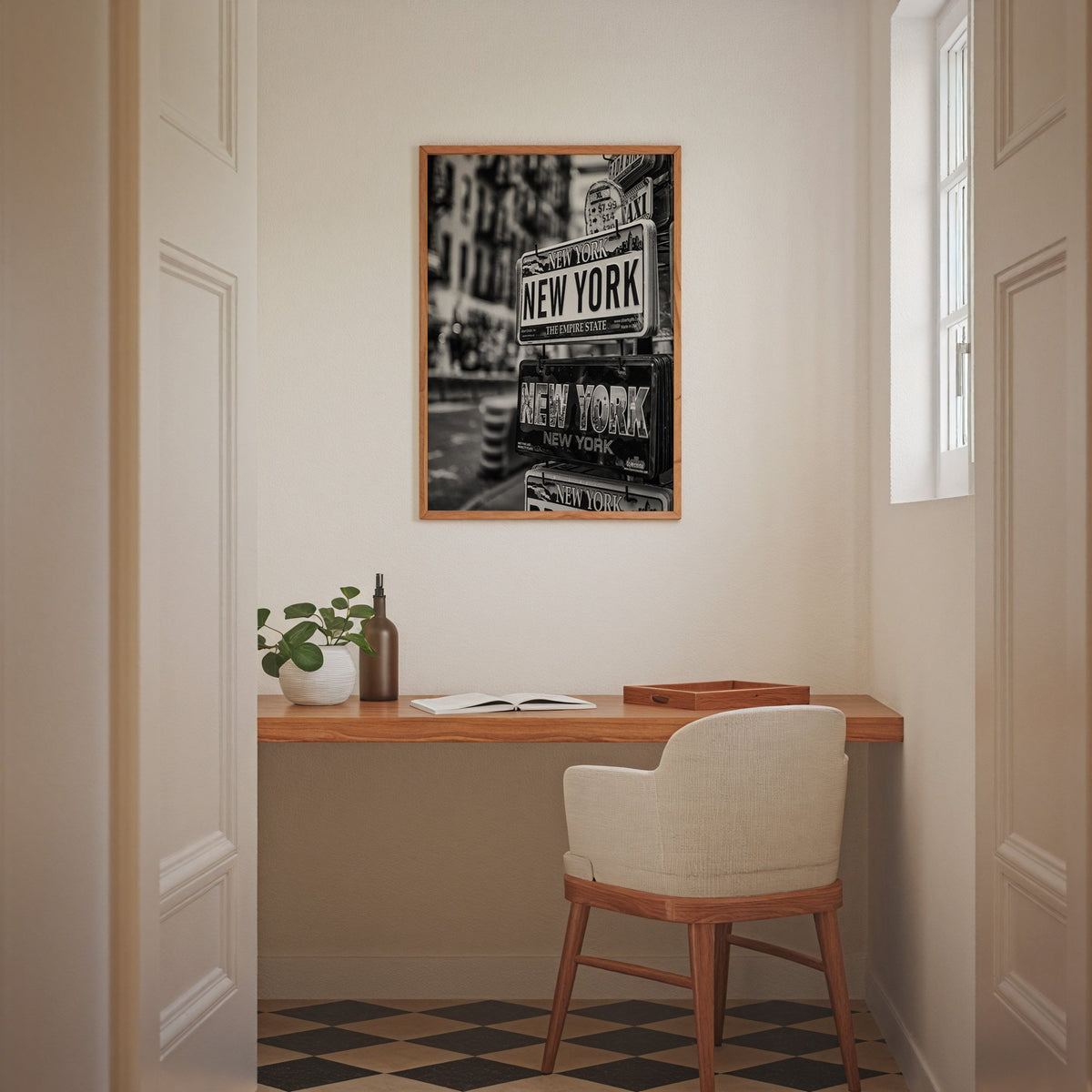 New York souvenir license plates on a rack print in an oak frame above a home office desk nook