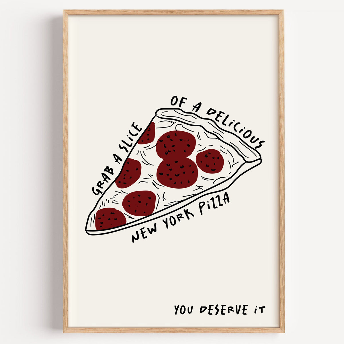 New York pizza slice print in a light oak frame on a plain white wall