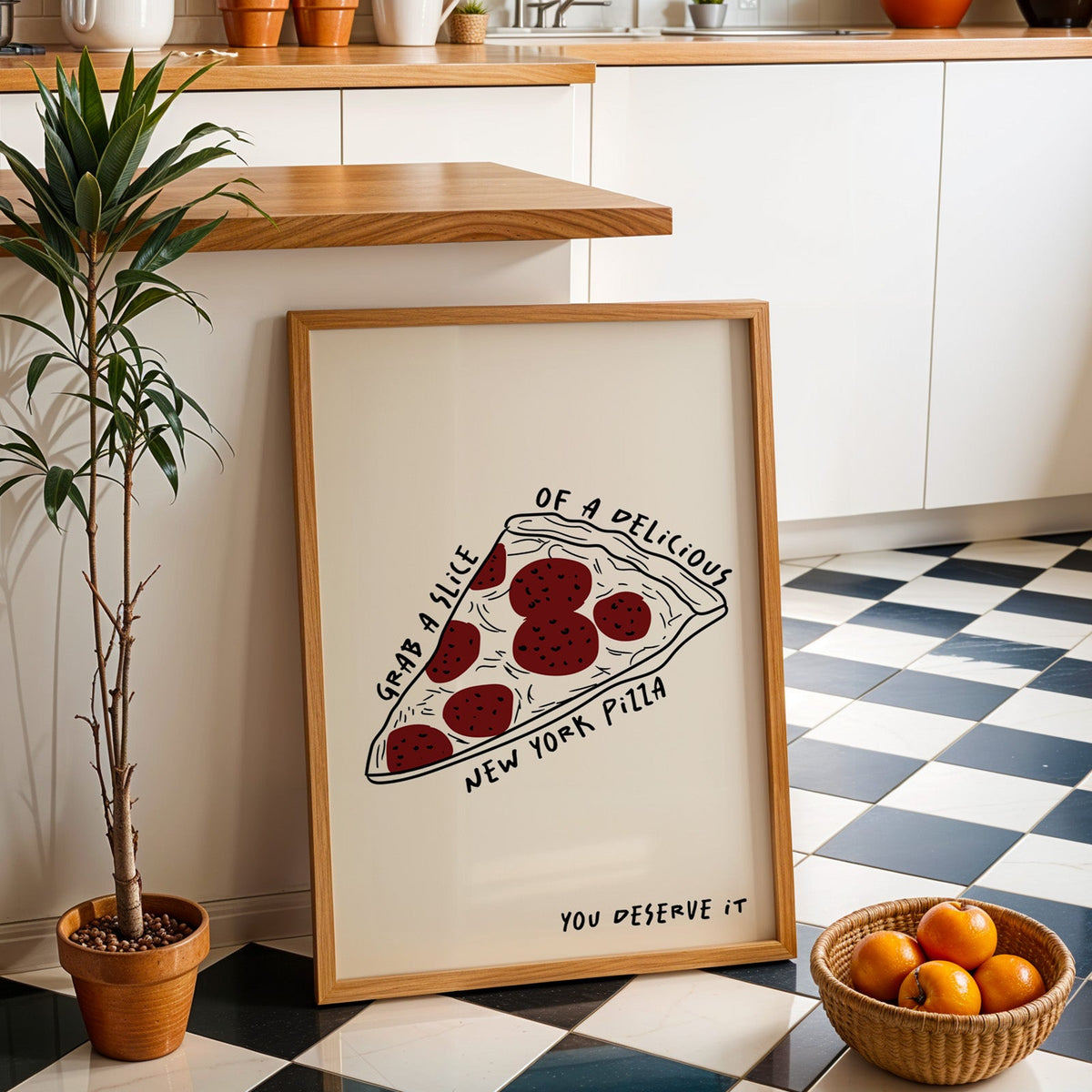 New York pizza slice print in an oak frame by a kitchen island and checkered floor