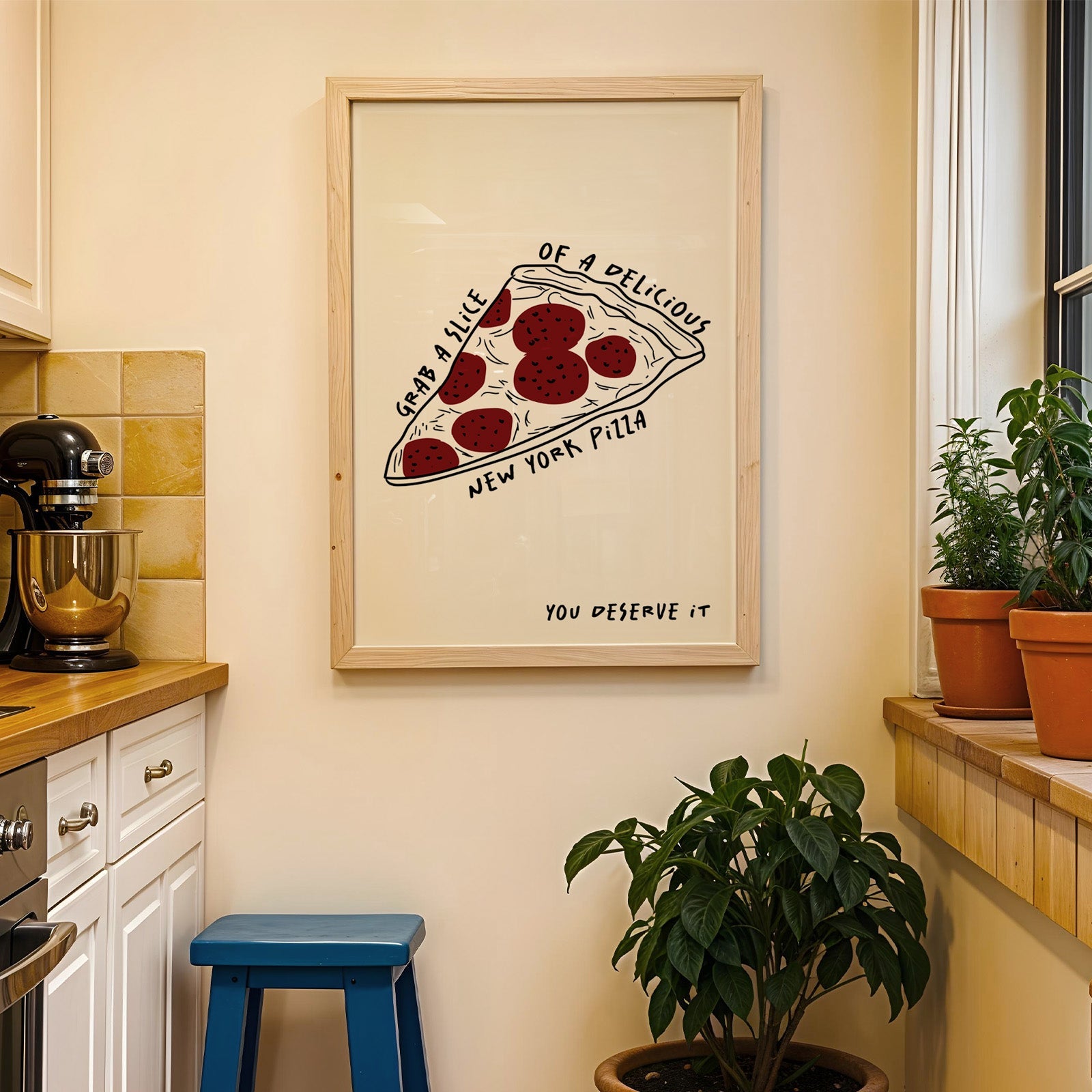New York pizza slice print in a wood frame on a yellow tiled kitchen wall