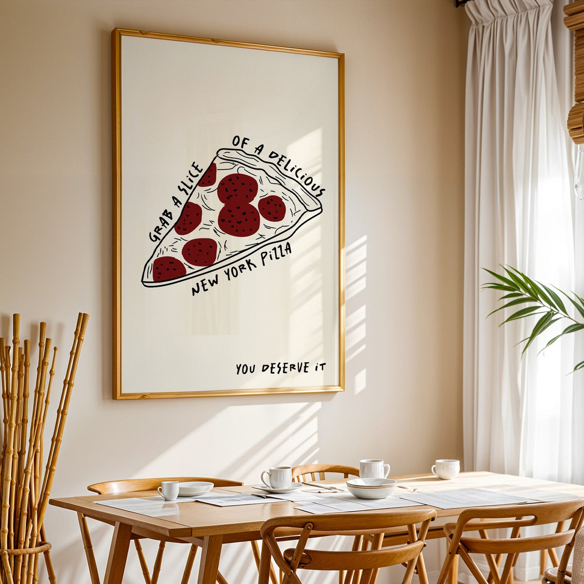 New York pizza slice print in a gold frame above a sunlit breakfast table