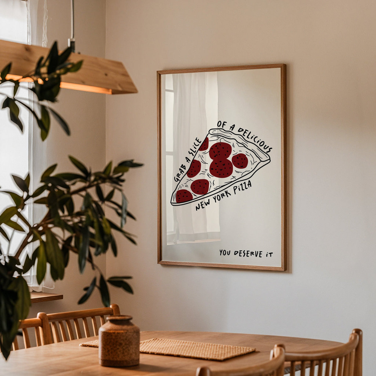 New York pizza slice print in a walnut frame above a dining table beside an olive tree