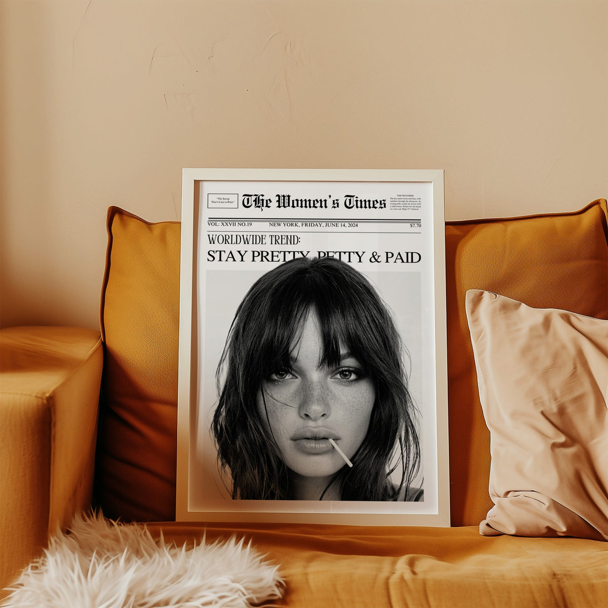 Mock front page with close-up of woman and lollipop print in a white frame leaning on a mustard velvet sofa