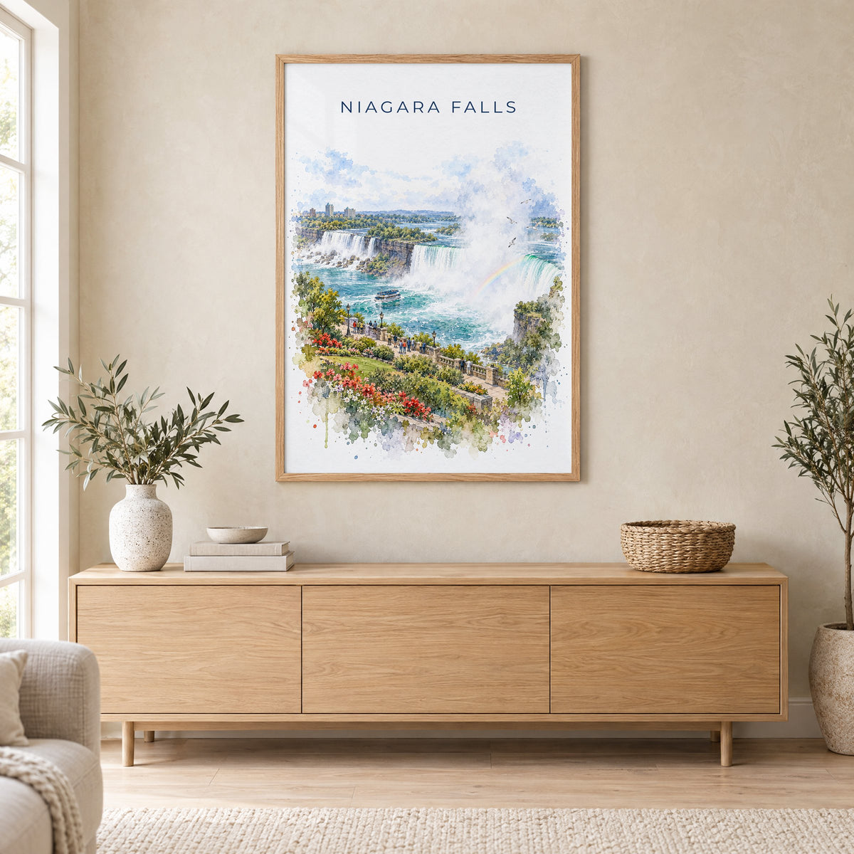 Niagara Falls watercolor print in an oak frame above a light wood sideboard in a Scandinavian living room