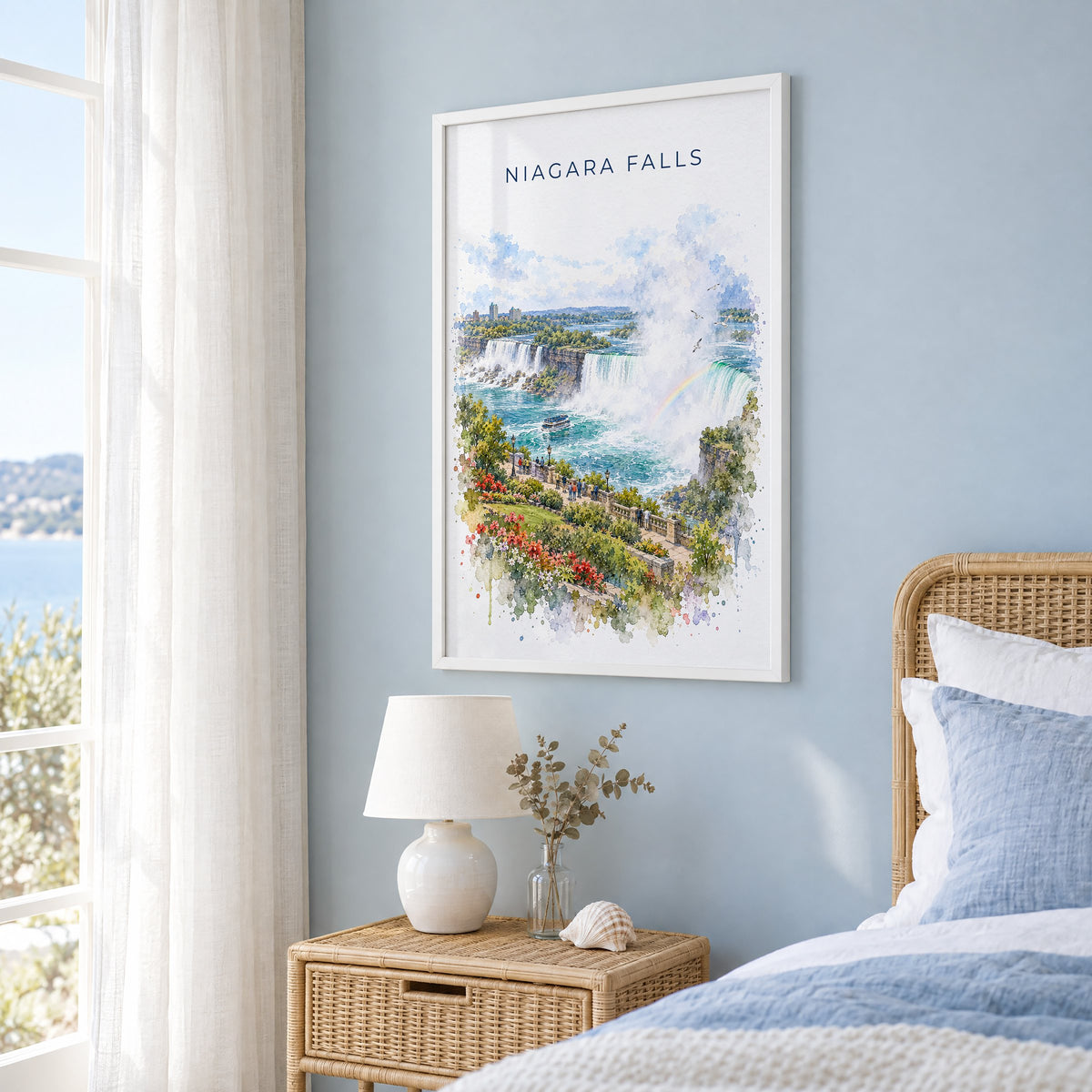 Niagara Falls watercolor print in a white frame on a pale blue wall beside a rattan bed in a coastal bedroom