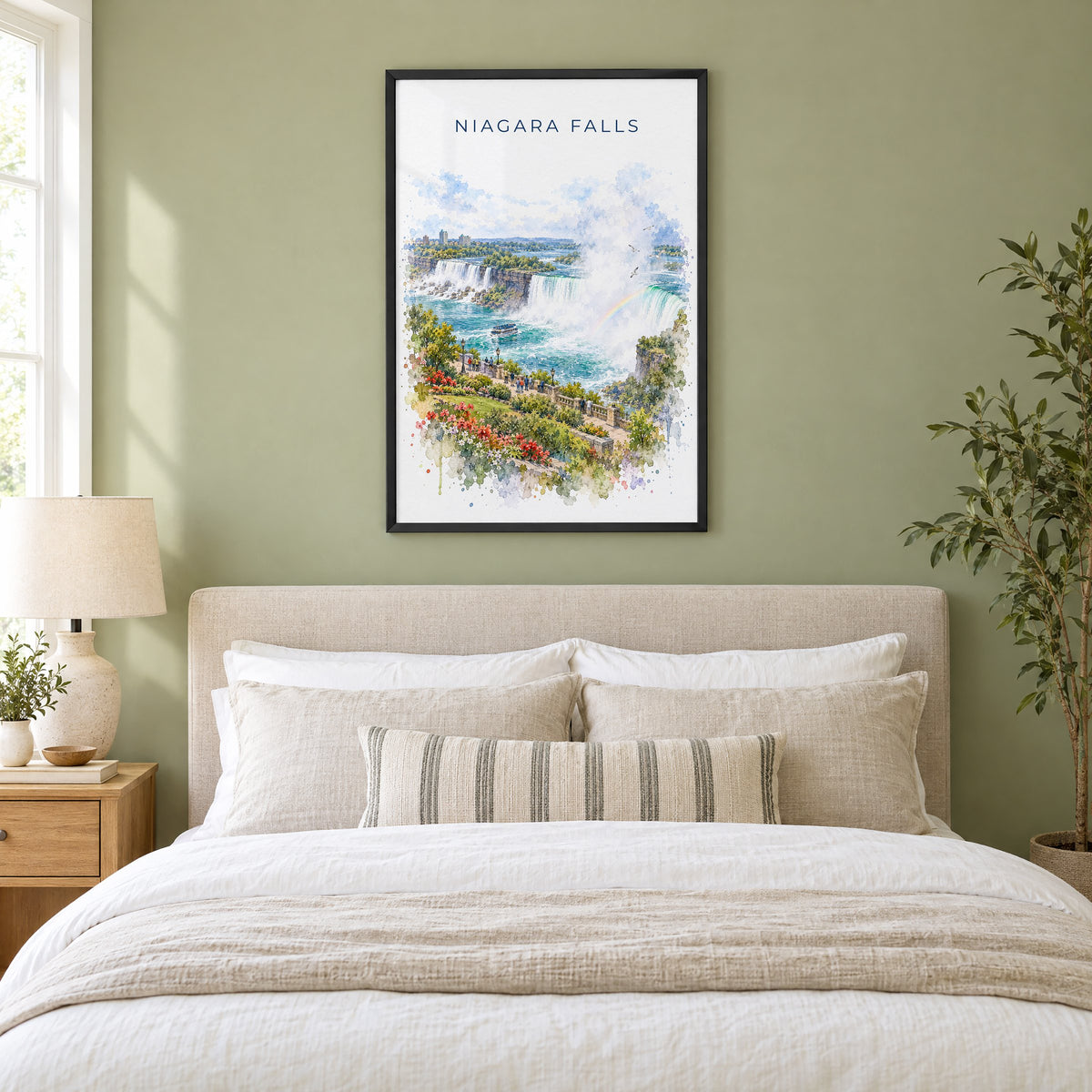 Niagara Falls watercolor print in a black frame above an upholstered headboard in a sage green bedroom