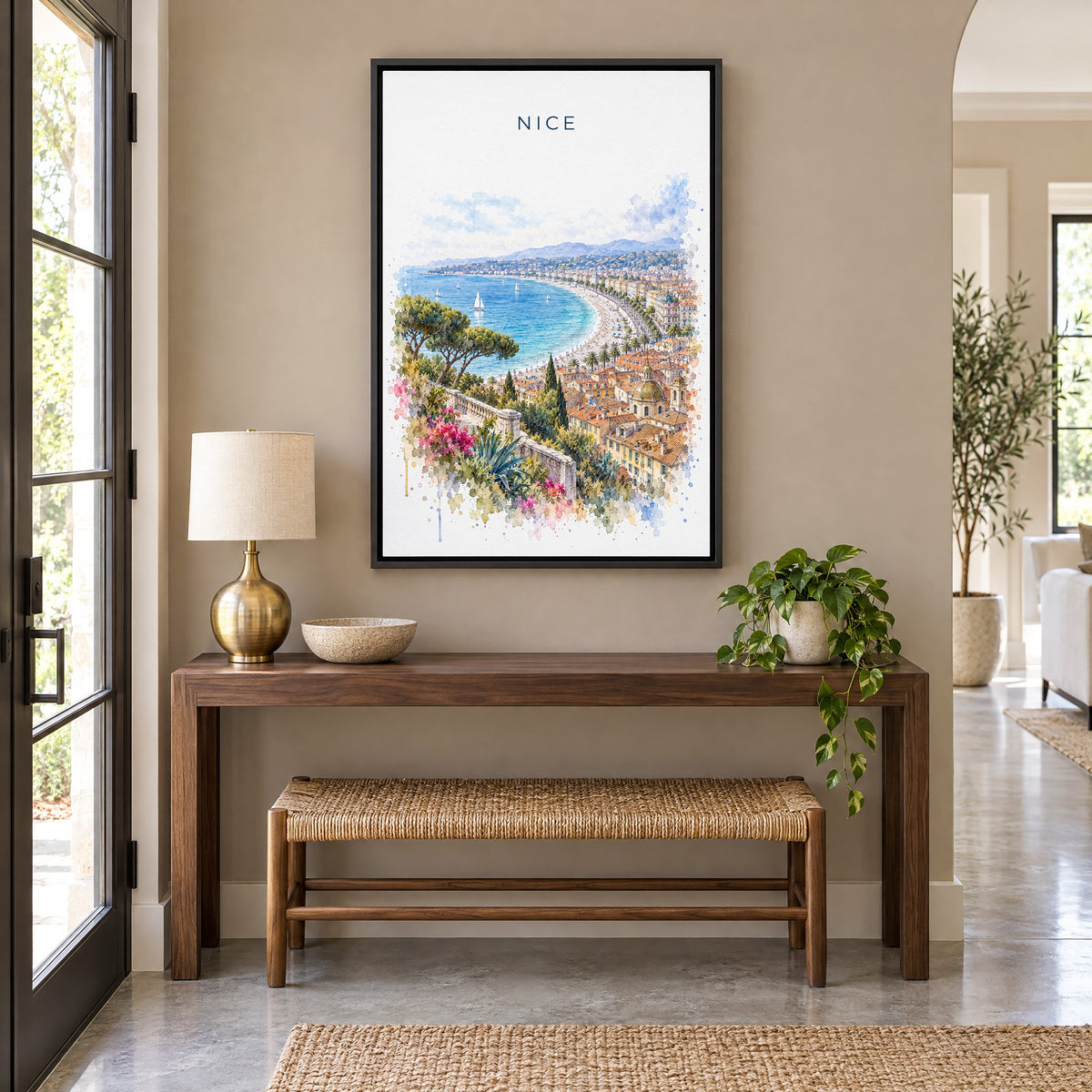 Nice, France watercolor print as a black floater canvas above a walnut console and woven bench in an entryway