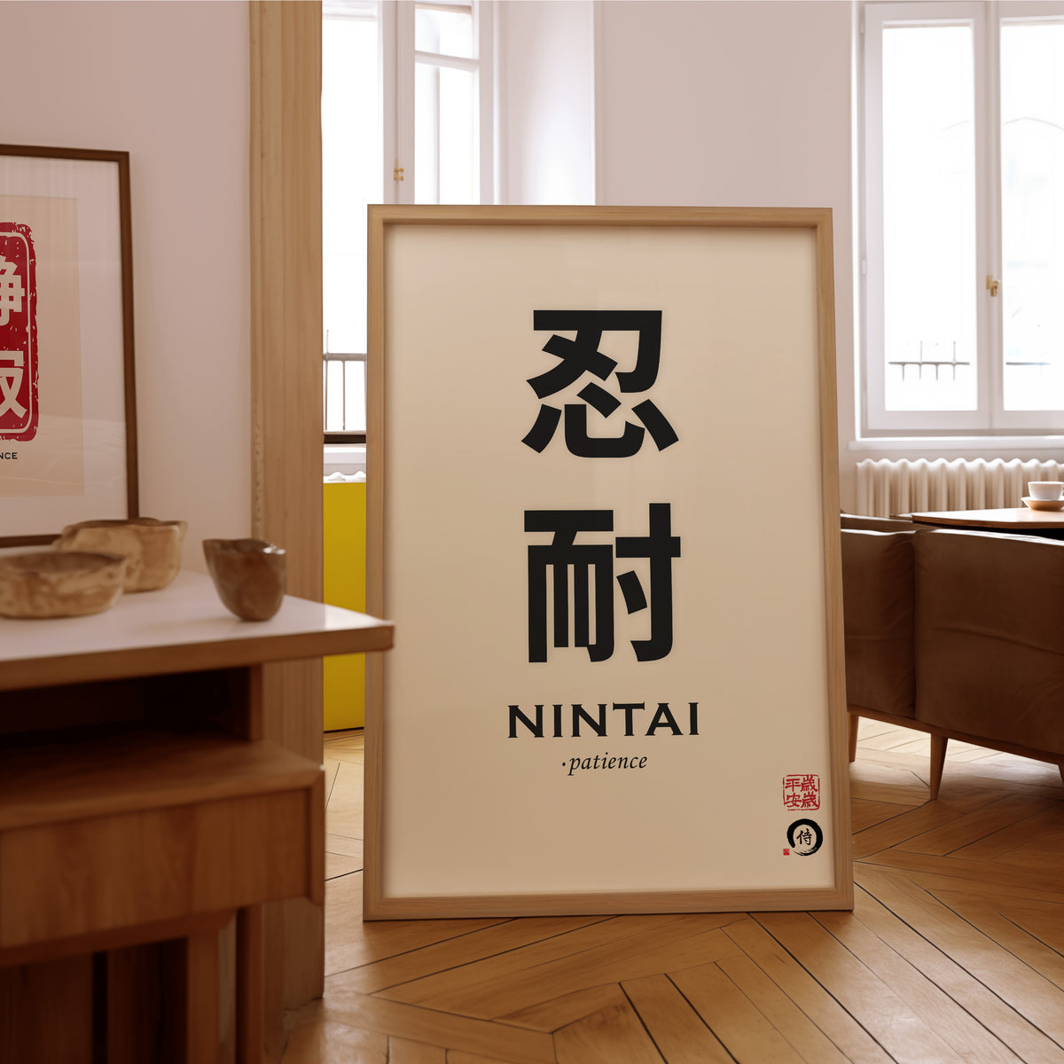 Nintai patience kanji print in an oak frame on the parquet floor of a sunlit living room