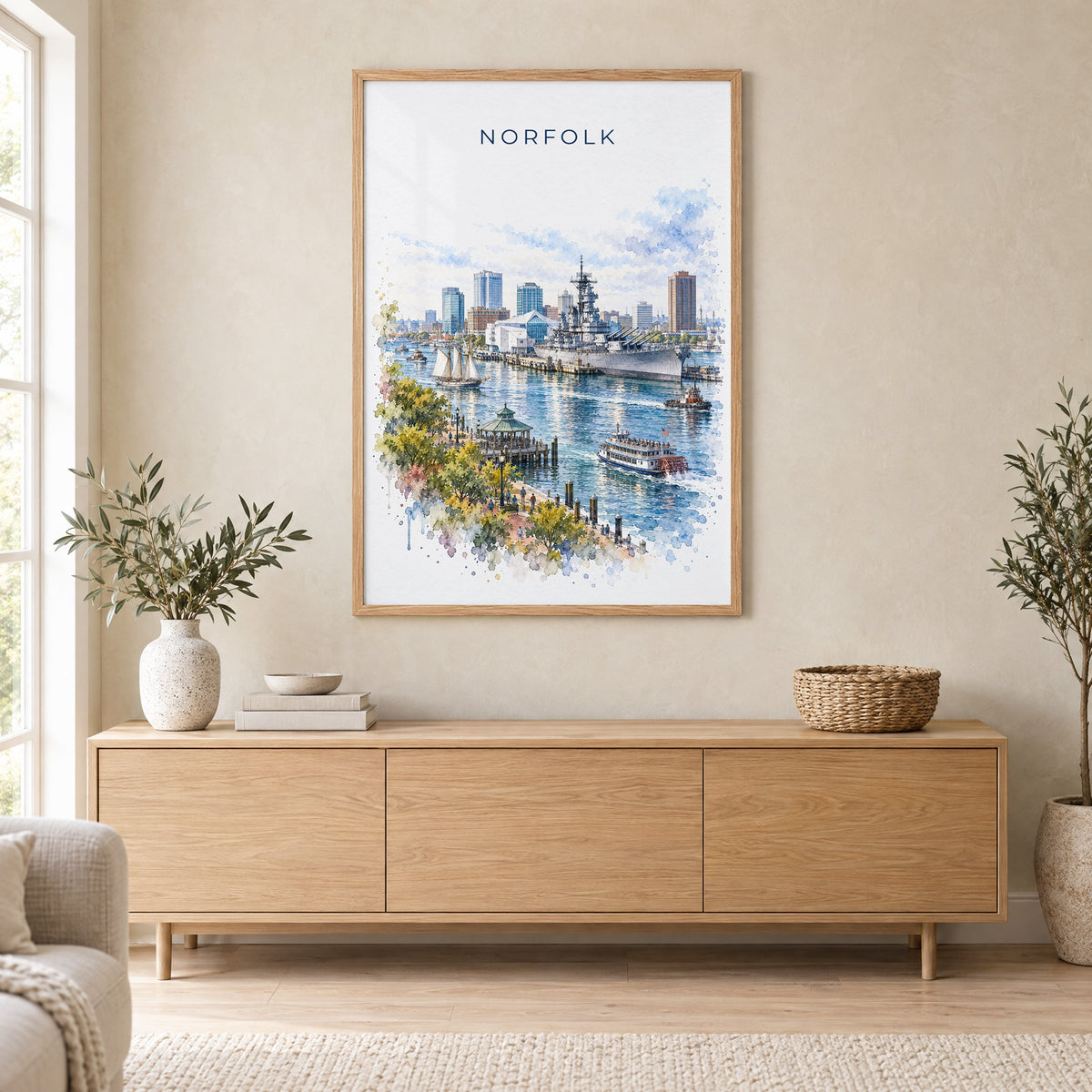 Norfolk, Virginia watercolor print in an oak frame above a light wood sideboard in a Scandinavian living room