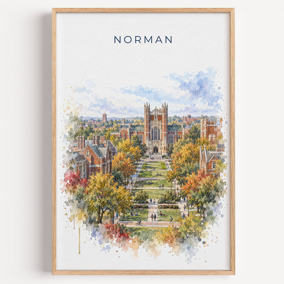 Norman, Oklahoma watercolor print in a light oak frame on a plain white wall