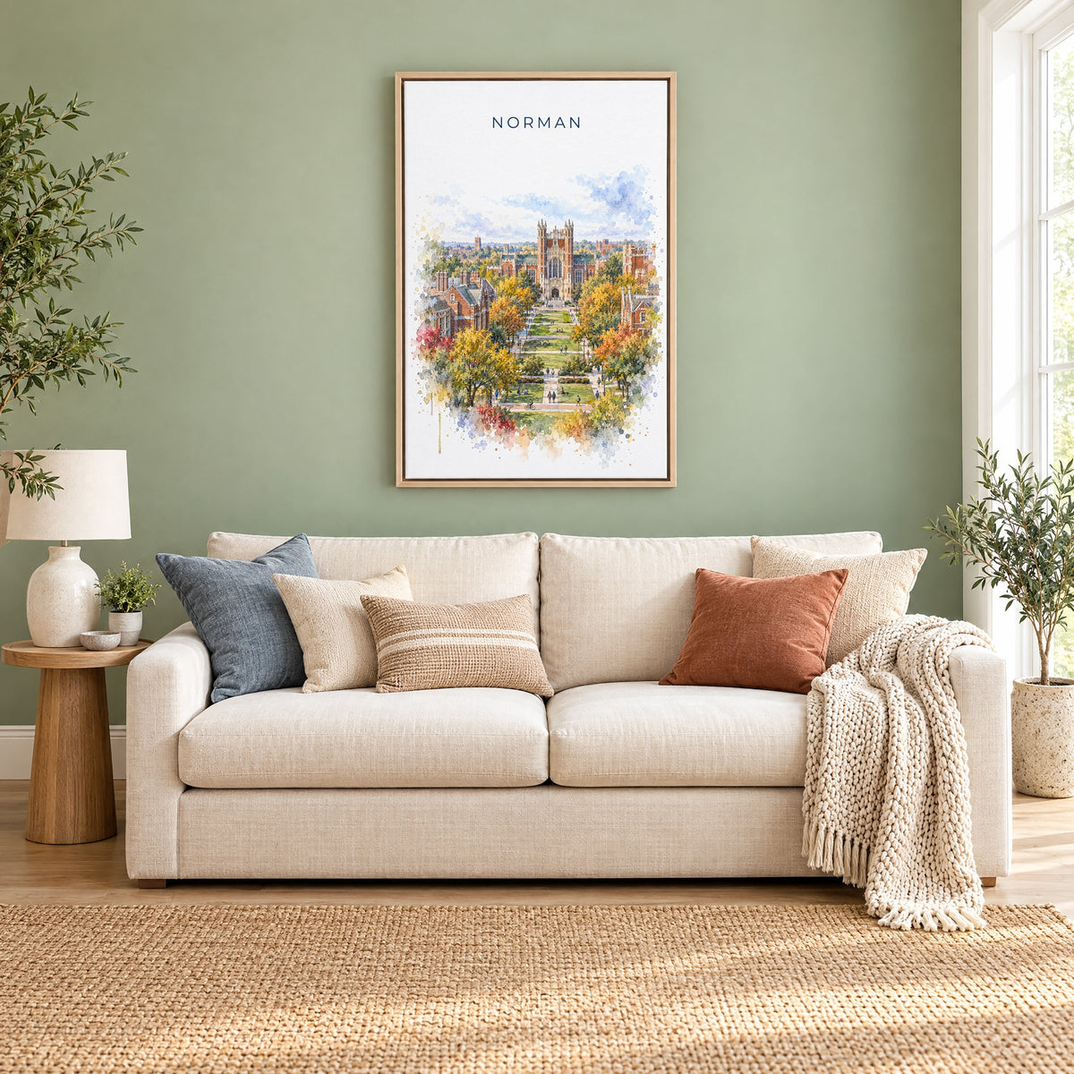 Norman, Oklahoma watercolor print as a natural floater canvas above a cream linen sofa on a sage green wall