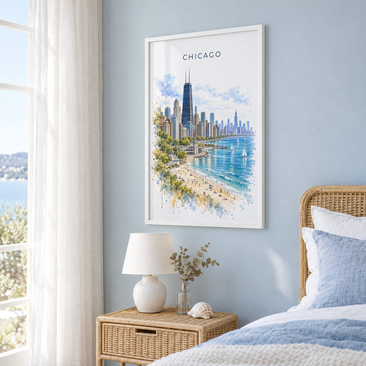 North Avenue Beach Chicago watercolor print in a white frame on a pale blue wall beside a rattan bed in a coastal bedroom