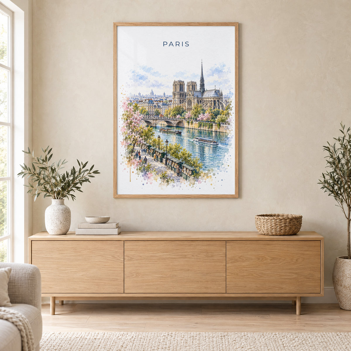Notre-Dame Paris watercolor print in an oak frame above a light wood sideboard in a Scandinavian living room