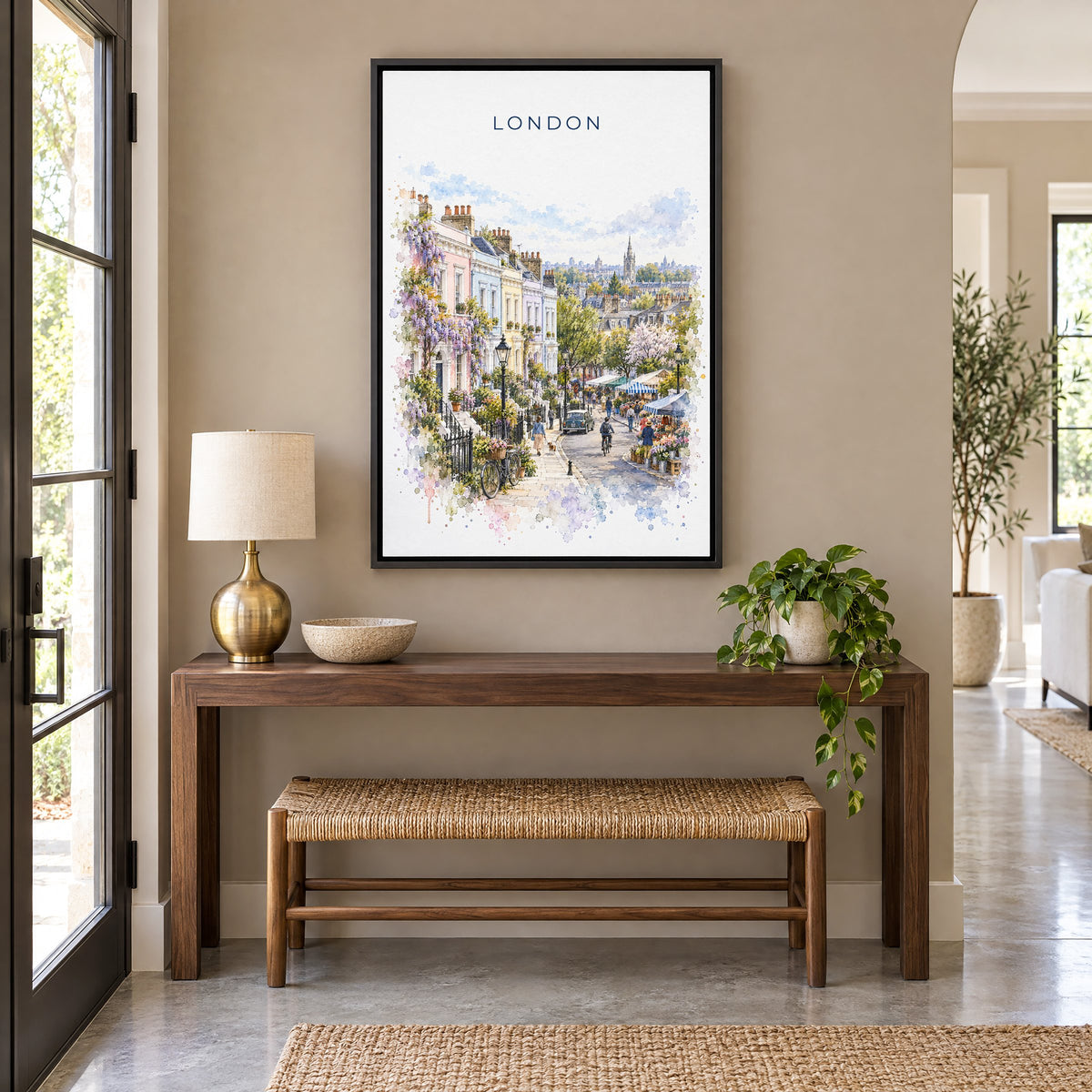 Notting Hill London watercolor print as a black floater canvas above a walnut console and woven bench in an entryway