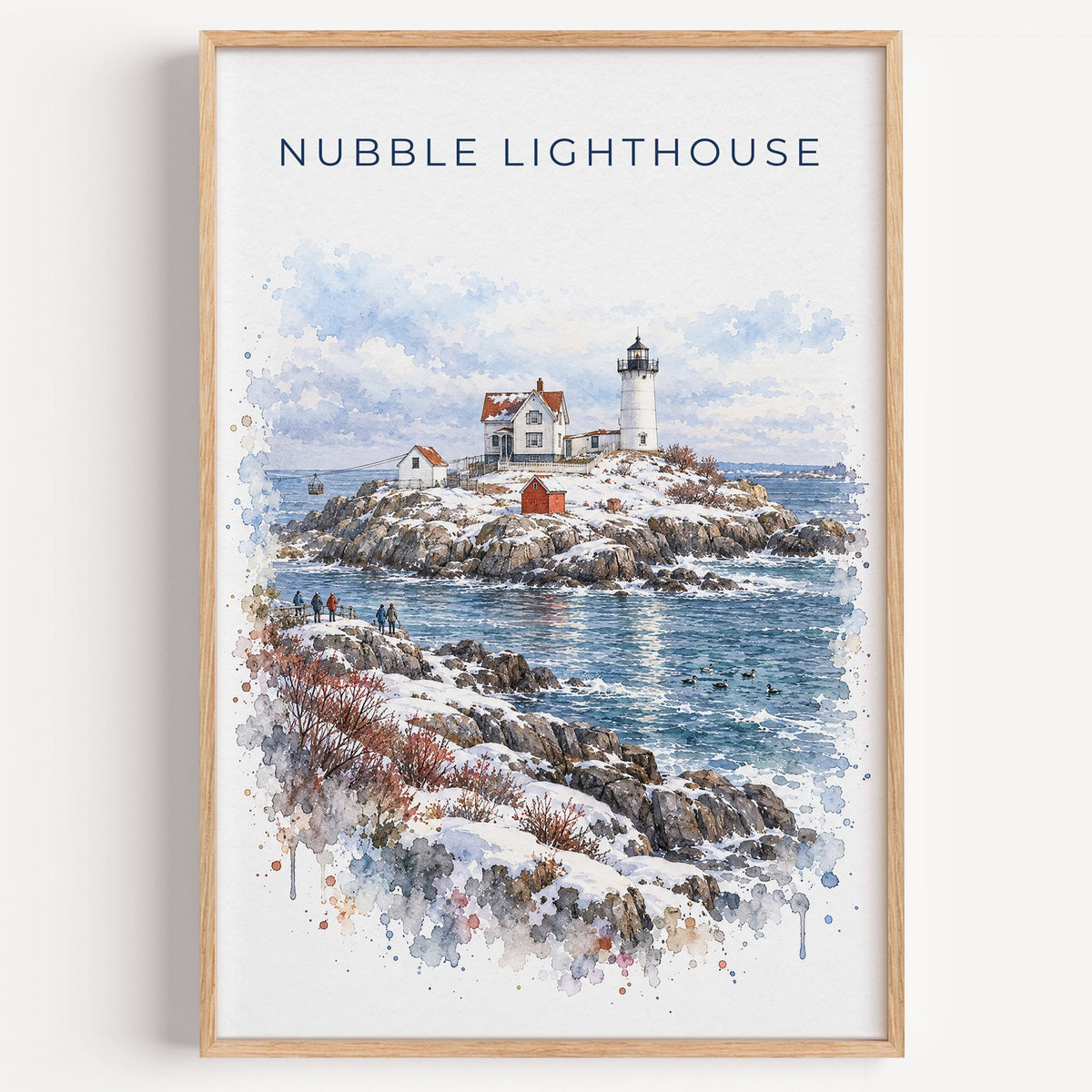 Nubble Lighthouse watercolor print in a light oak frame on a plain white wall