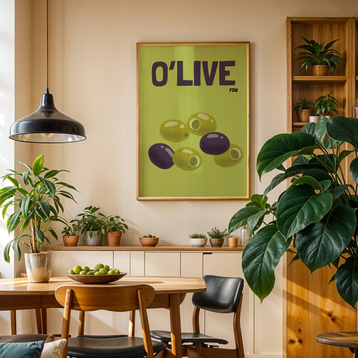 O Live You olives print in an oak frame in a dining room above a plant-lined sideboard