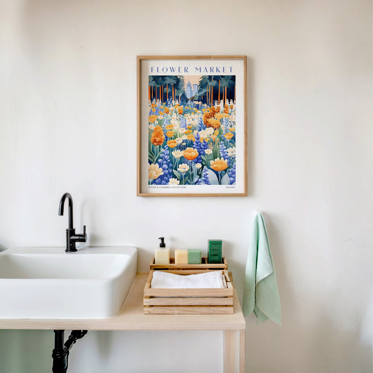 Oakland flower market print in an oak frame above a white bathroom sink with folded towels