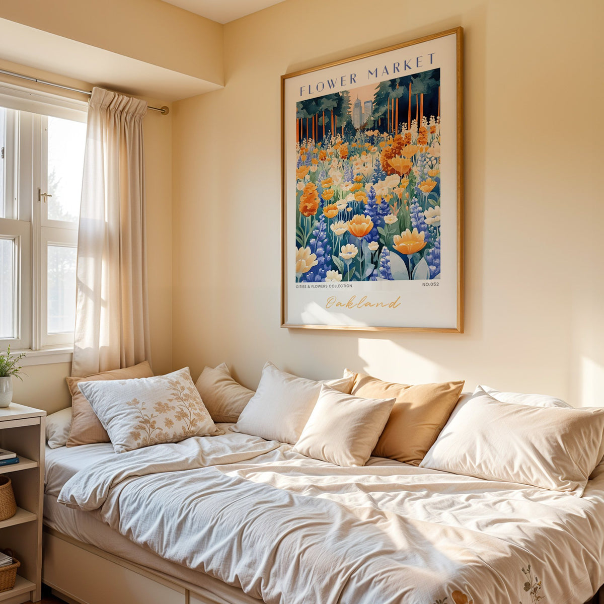 Oakland flower market print in an oak frame above a cream daybed in a sunny bedroom