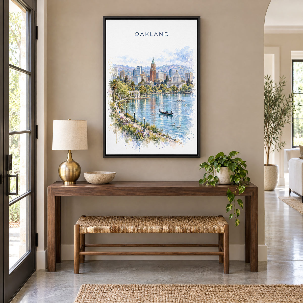Oakland watercolor print as a black floater canvas above a walnut console and woven bench in an entryway