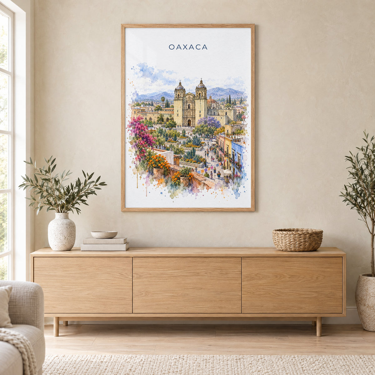 Oaxaca watercolor print in an oak frame above a light wood sideboard in a Scandinavian living room