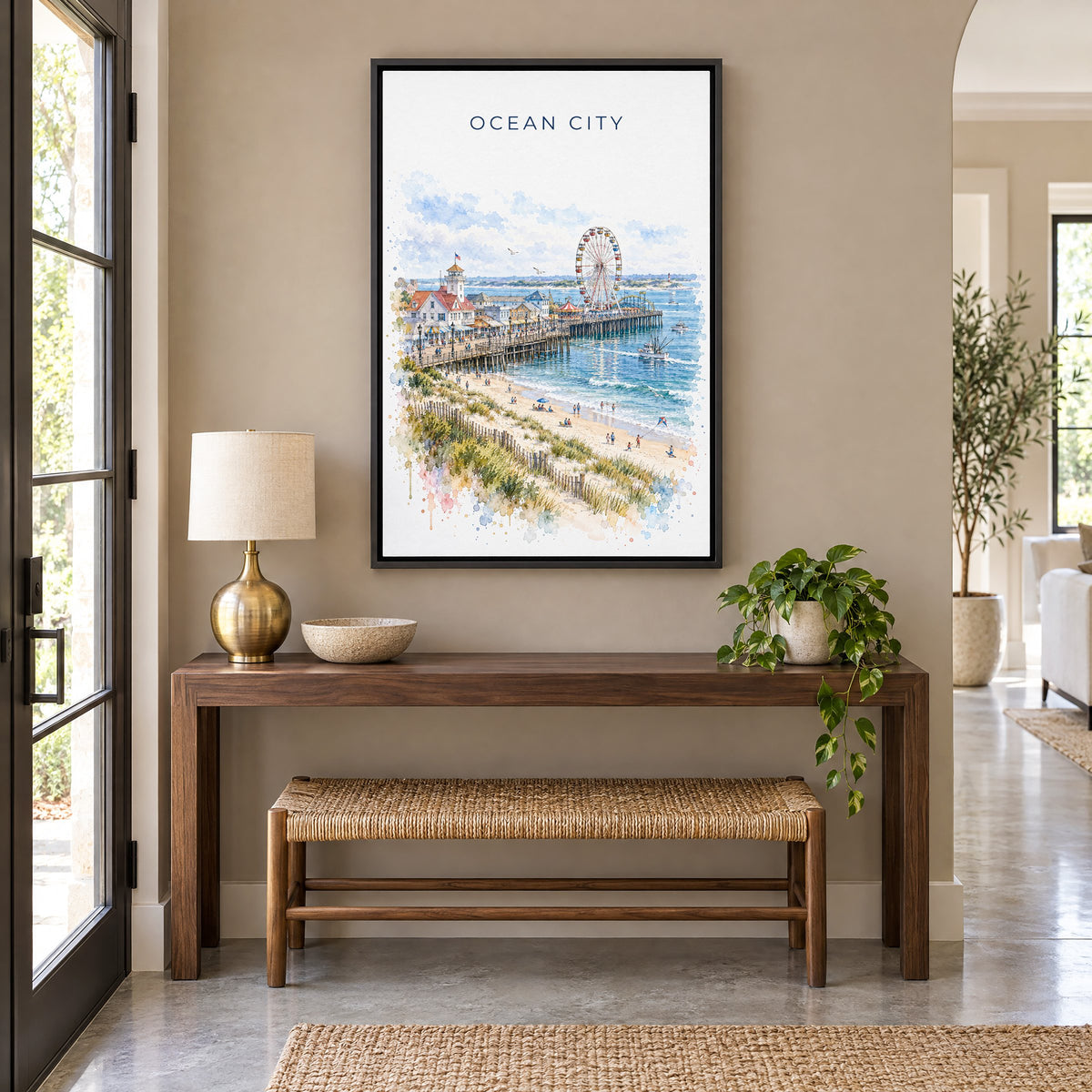 Ocean City, Maryland watercolor print as a black floater canvas above a walnut console and woven bench in an entryway