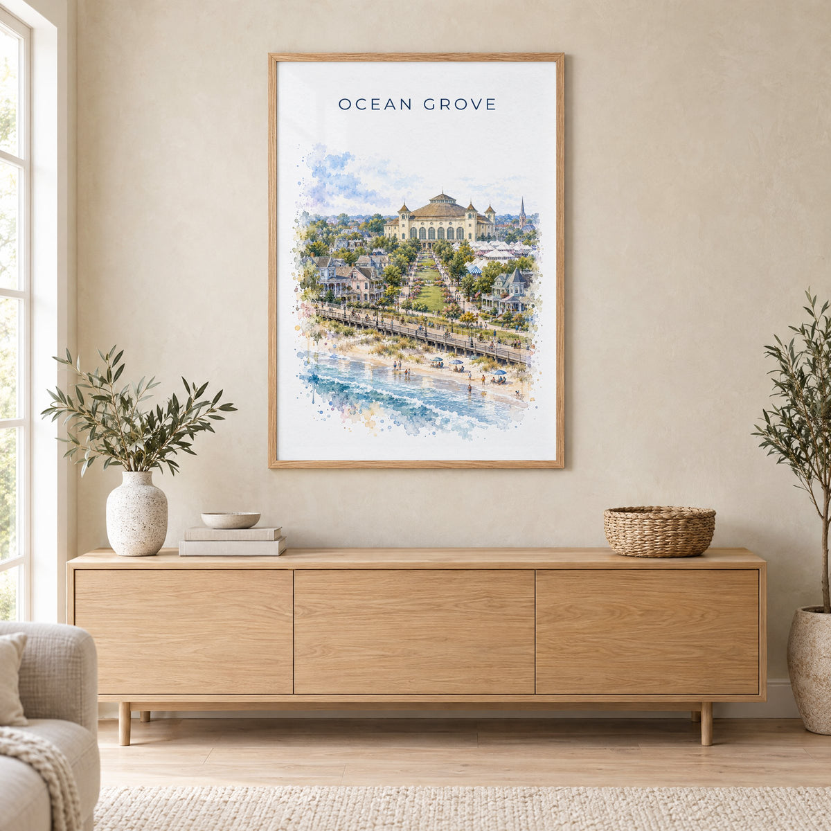 Ocean Grove, New Jersey watercolor print in an oak frame above a light wood sideboard in a Scandinavian living room