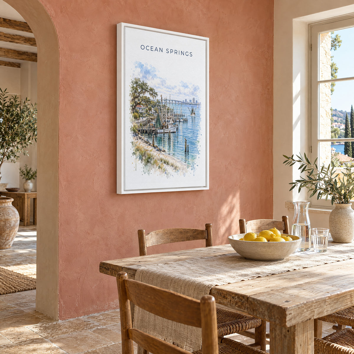 Ocean Springs, Mississippi watercolor print as a white floater canvas on a terracotta wall above a rustic dining table