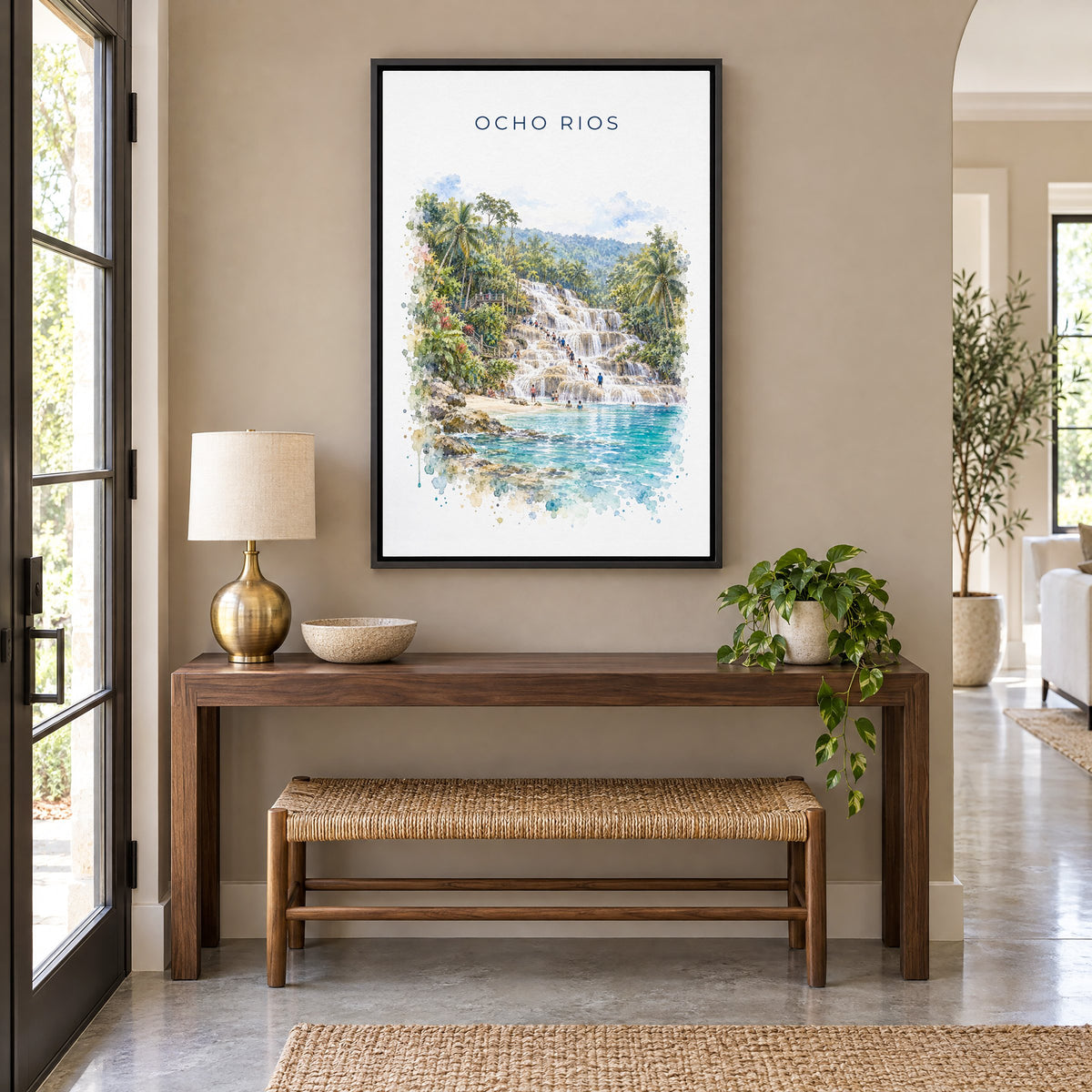Ocho Rios watercolor print as a black floater canvas above a walnut console and woven bench in an entryway