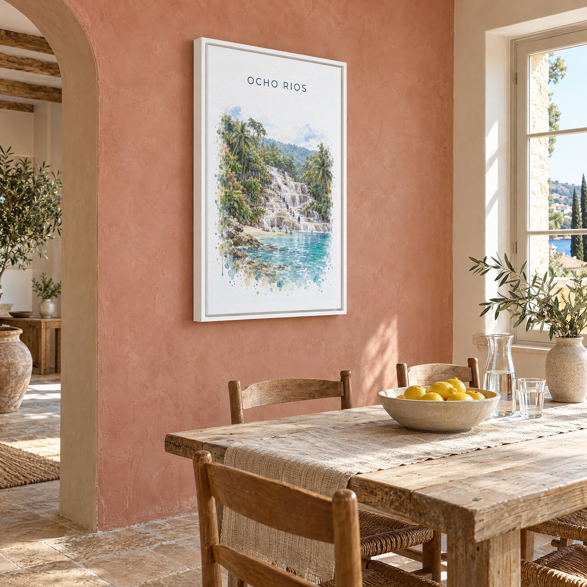 Ocho Rios watercolor print as a white floater canvas on a terracotta wall above a rustic dining table