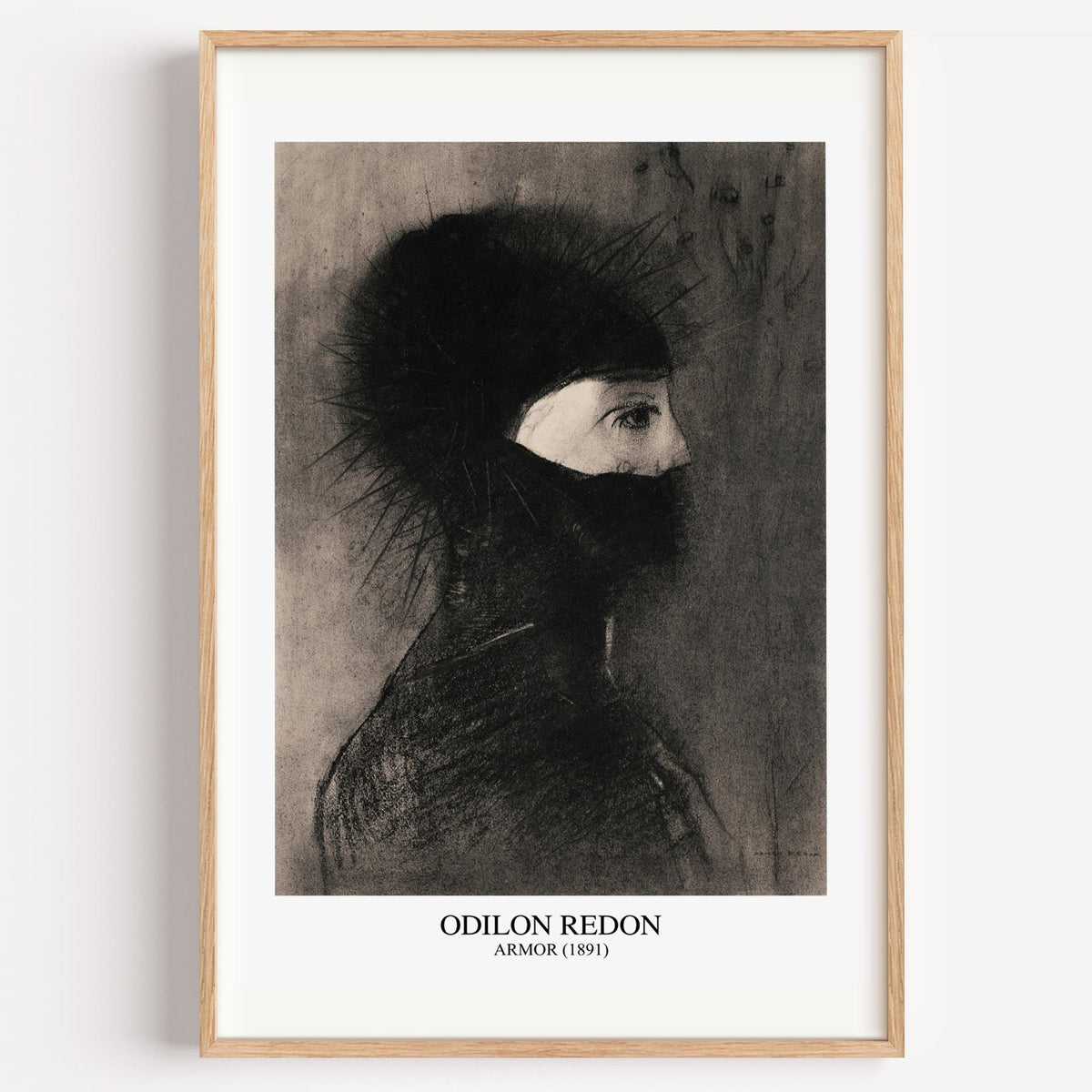 Odilon Redon Armor charcoal drawing print in a light oak frame on a white wall