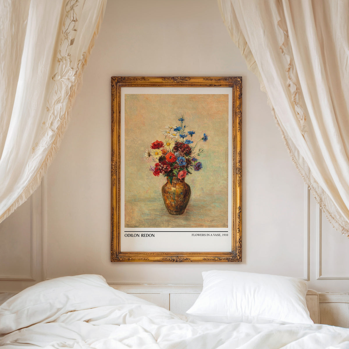 Redon flower print shown in an ornate gold frame above a canopy bed