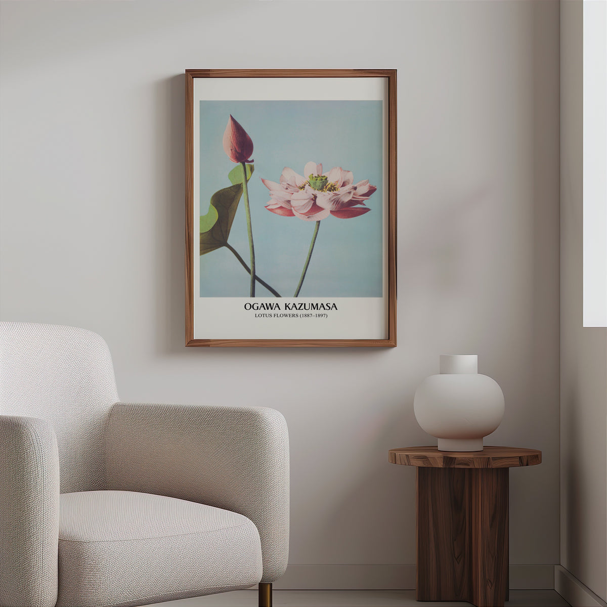 Lotus botanical print in a slim walnut frame above a bouclé armchair