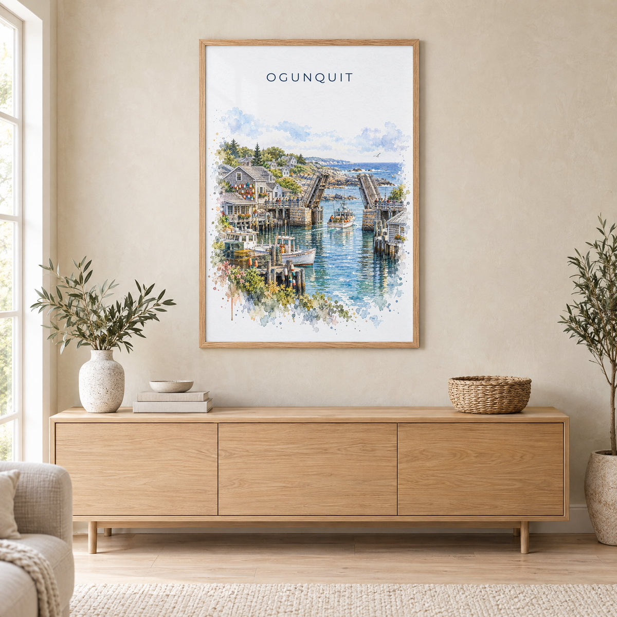 Ogunquit watercolor print in an oak frame above a light wood sideboard in a Scandinavian living room