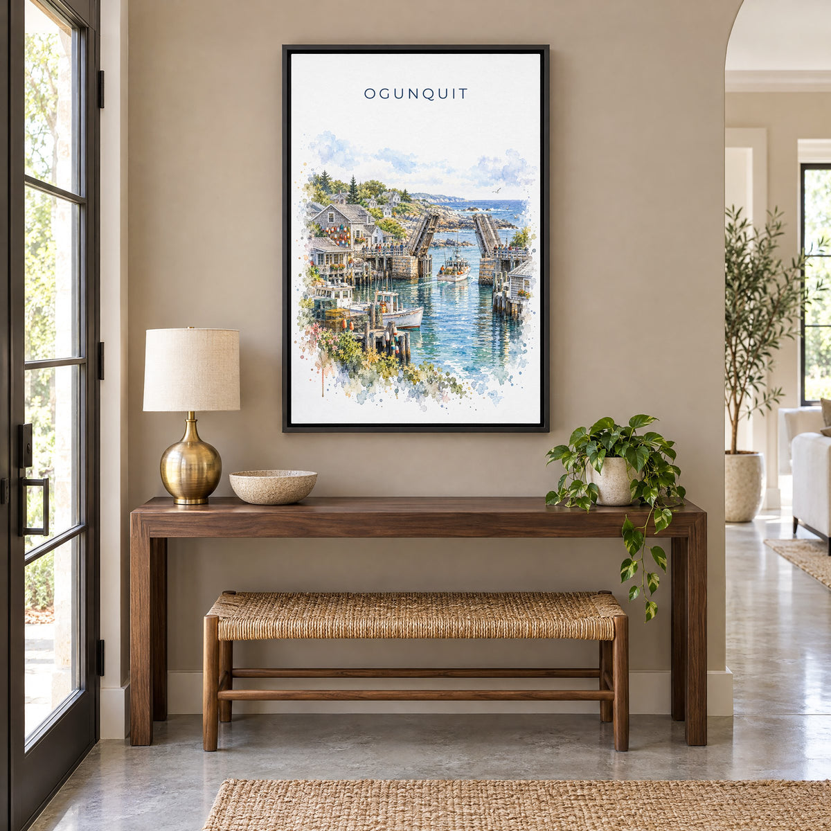 Ogunquit watercolor print as a black floater canvas above a walnut console and woven bench in an entryway
