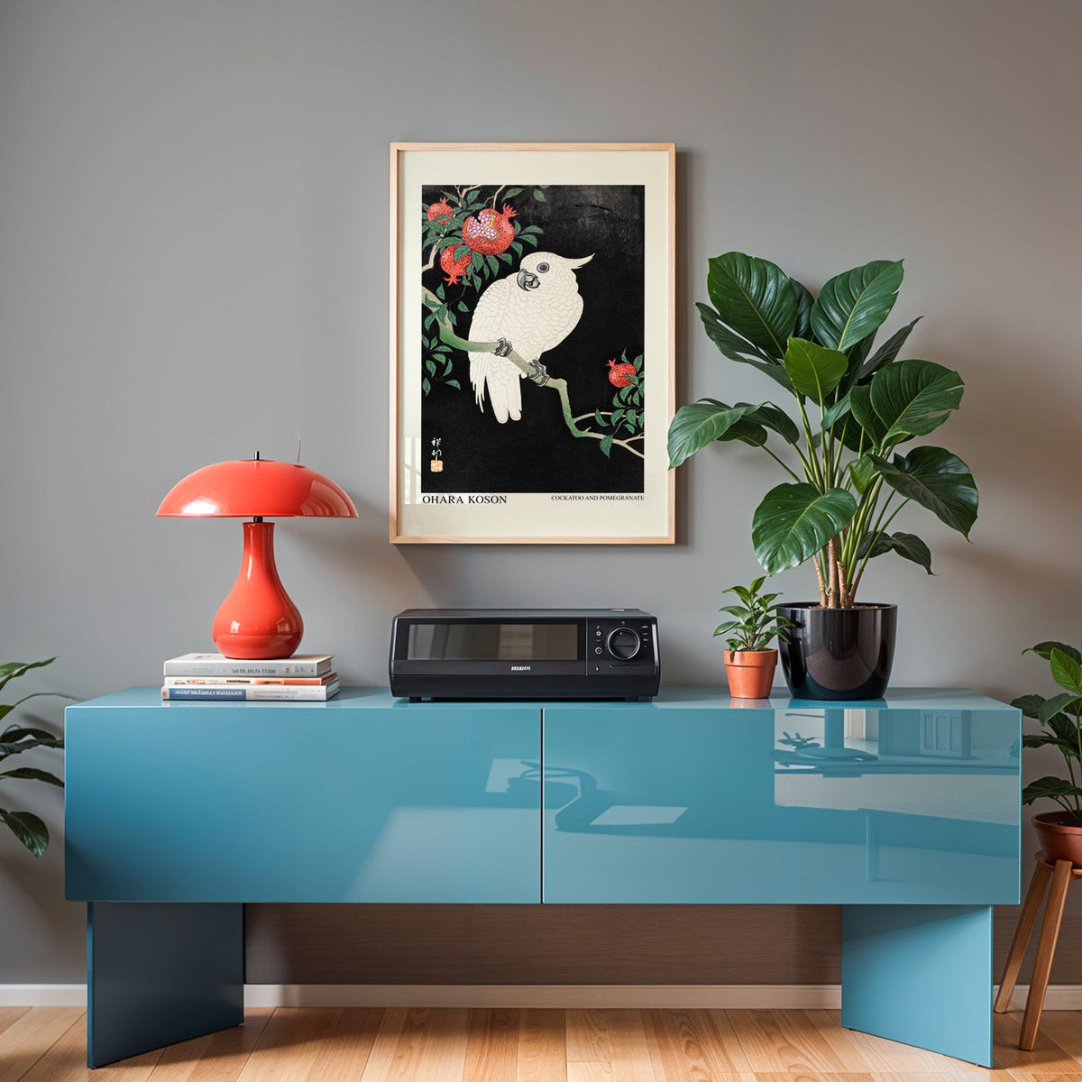 Japanese bird woodblock print in an oak frame above a teal sideboard
