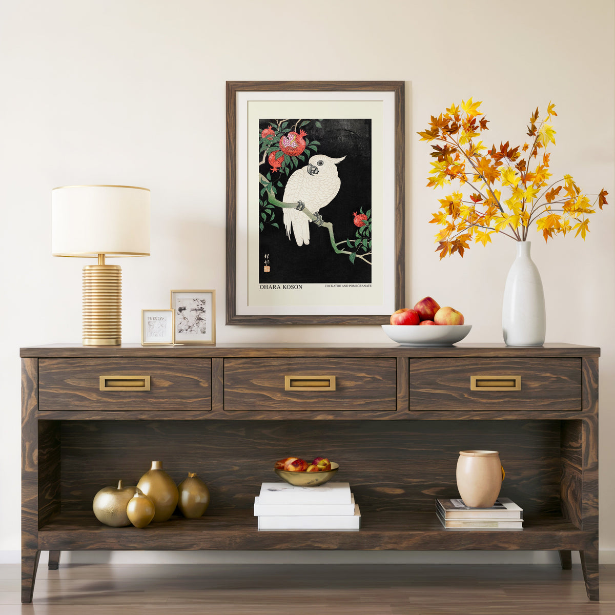 Cockatoo and Pomegranate print in a walnut frame above a console with branches