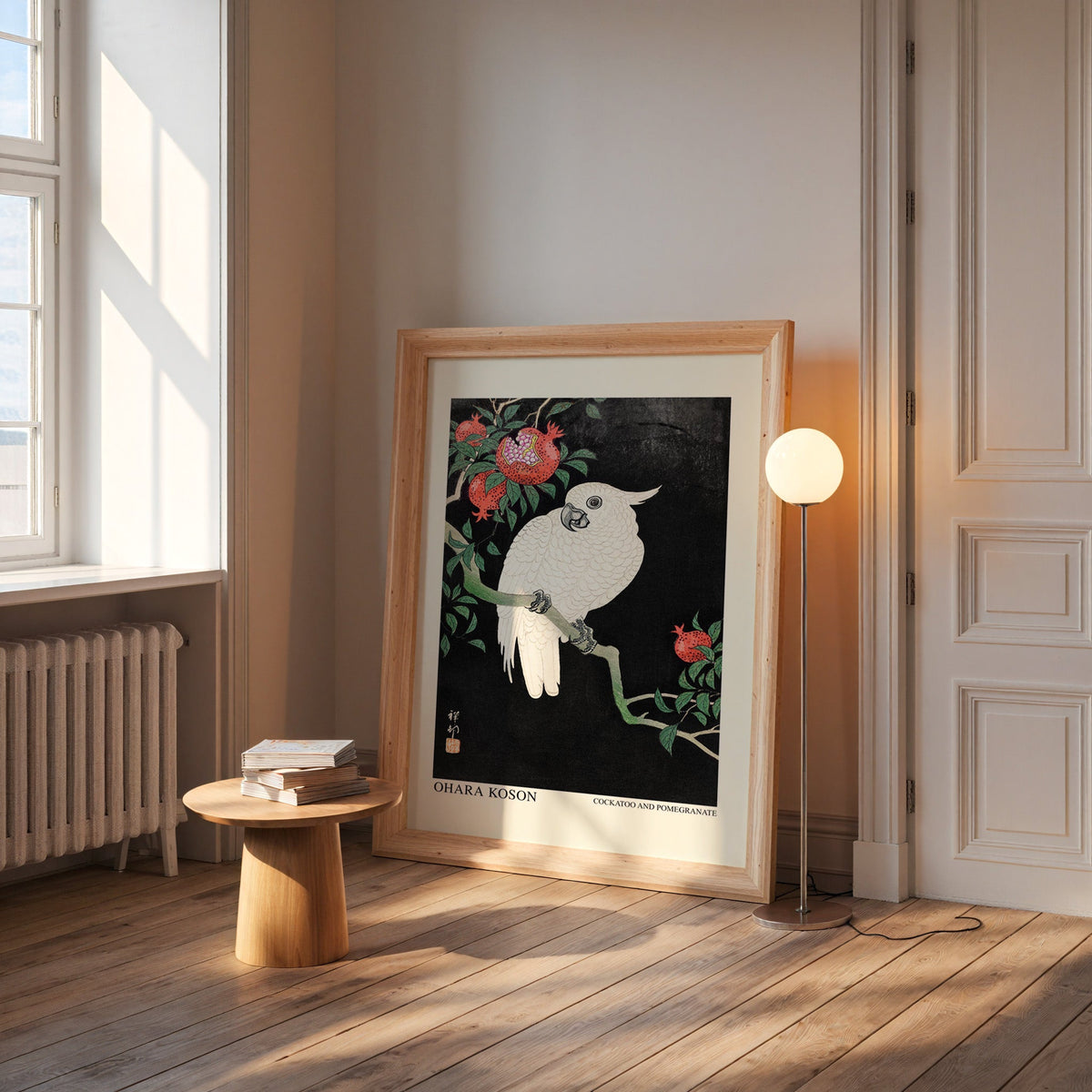 Koson cockatoo print in a wide pine frame leaning by a sunlit window