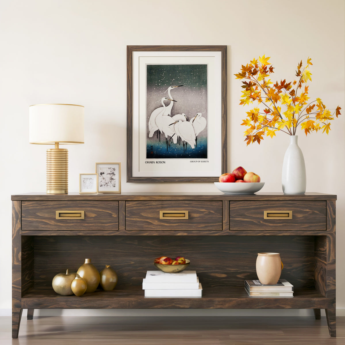 Group of Egrets print in a walnut frame above a console with autumn branches