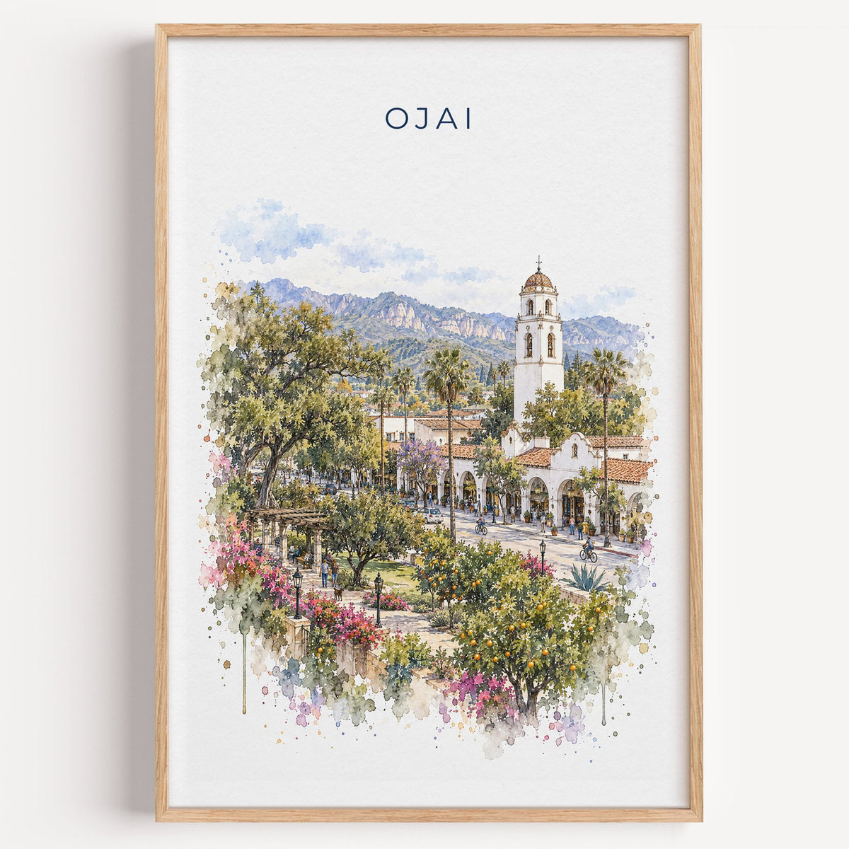 Ojai, California watercolor print in a light oak frame on a plain white wall